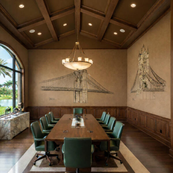 Headquarters & Offices A formal boardroom with dark wood-paneled walls and a high coffered ceiling. A long wooden table is centered in the room, surrounded by green leather rolling chairs. Two large, hand-drawn style murals of iconic bridges—the Brooklyn Bridge & Tower Bridge.